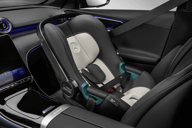 Abgebildet ist der schwarze Innenraum eines Fahrzeuges. Darin befindet sich, auf dem Beifahrerplatz ein Baby-Kindersitz. Der Kindersitz ist schwarz und beige. Das Bild verlinkt zu der Kategorie Kindersitze und Zubehör.